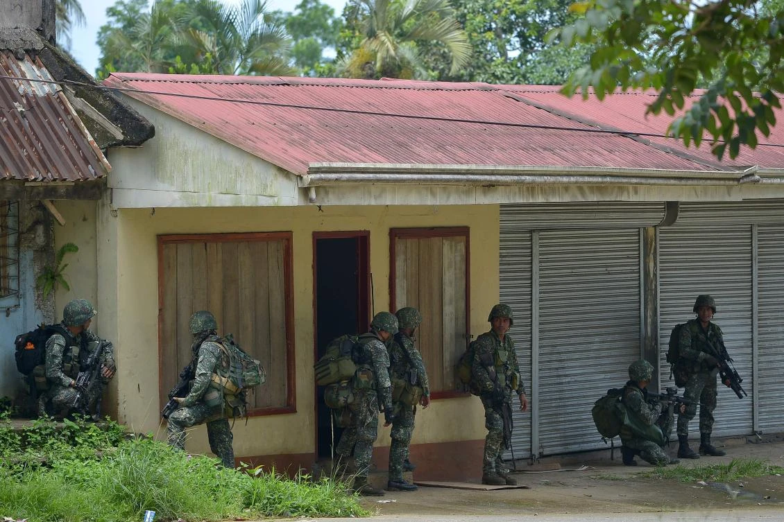 Philipine marines patrol a deserted street on their way to assault an Islamist militants' hideout in Marawi on the southern island of Mindanao. (AFP)