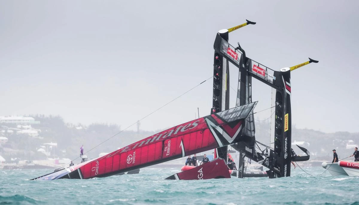Emirates Team New Zealand, skippered by Peter Burling, is seen capsizing at the start of race 5 of the 35th America’s Cup Challenger Playoffs semifinals in Bermuda’s Great Sound, on Tuesday. (AFP)