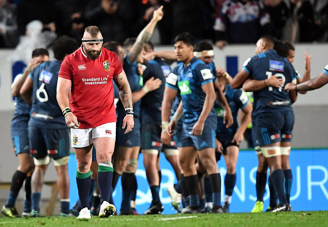 British and Irish Lions player Joe Marler walks away as Auckland Blues players celebrate after winning the game on Tuesday. (Reuters)