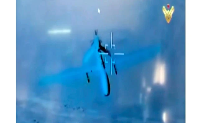 A still image taken from a footage broadcasted on Lebanese Hezbollah's Al Manar TV channel on Wednesday shows what it said had been filmed by an Iranian drone showing what is said to be a US military drone flying over southeast Syria. (Hezbollah's Al Manar TV via Reuters TV)