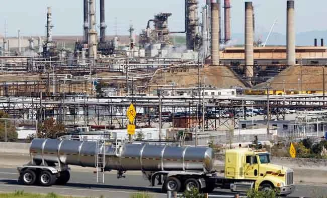 In this March 9, 2010, file photo, a tanker truck passes an oil refinery in Richmond, Calif. (AP)