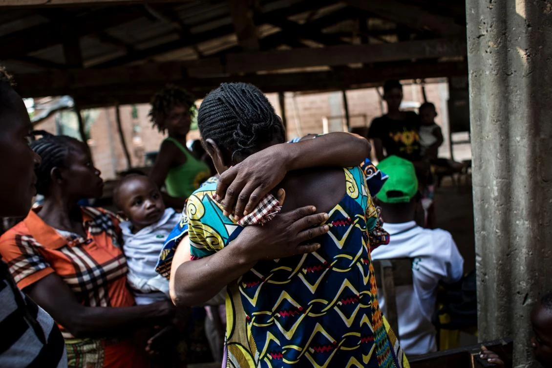 Internally Displaced Persons hug after finding each other at a registration site. (AFP)