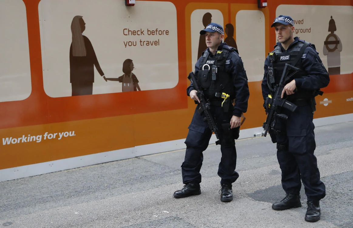 Two armed police officers patrol in the London Bridge area of London. (AP)