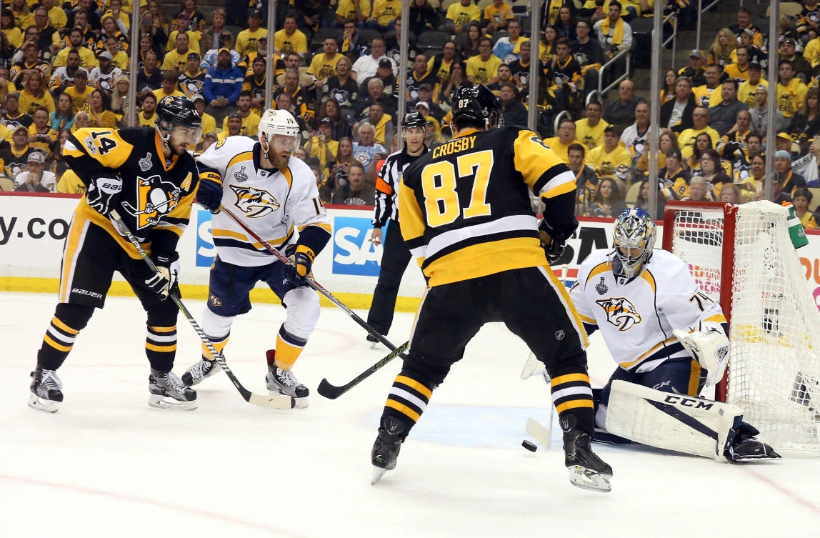 Nashville Predators goalie Juuse Saros (74) defends the goal against Pittsburgh Penguins center Sidney Crosby (87) and left wing Chris Kunitz (14) during the third period in Game five of the Stanley Cup finals at PPG PAINTS Arena on Thursday night. (USA TODAY Sports)