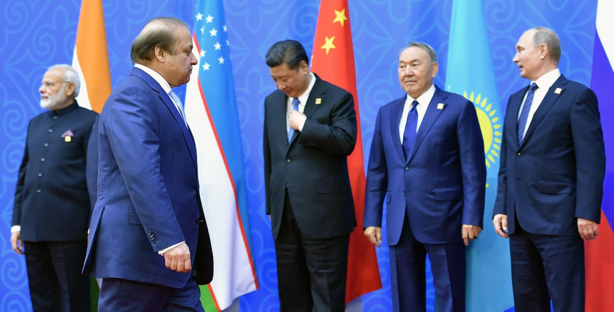 Pakistani Prime Minister Nawaz Sharif walks past Indian Prime Minister Narendra Modi, Chinese President Xi Jinping, Kazakh President Nursultan Nazarbayev and Russian President Vladimir Putin as he arrives for a family photo at the Shanghai Cooperation Organization (SCO) Summit in Astana on Friday. (AFP)