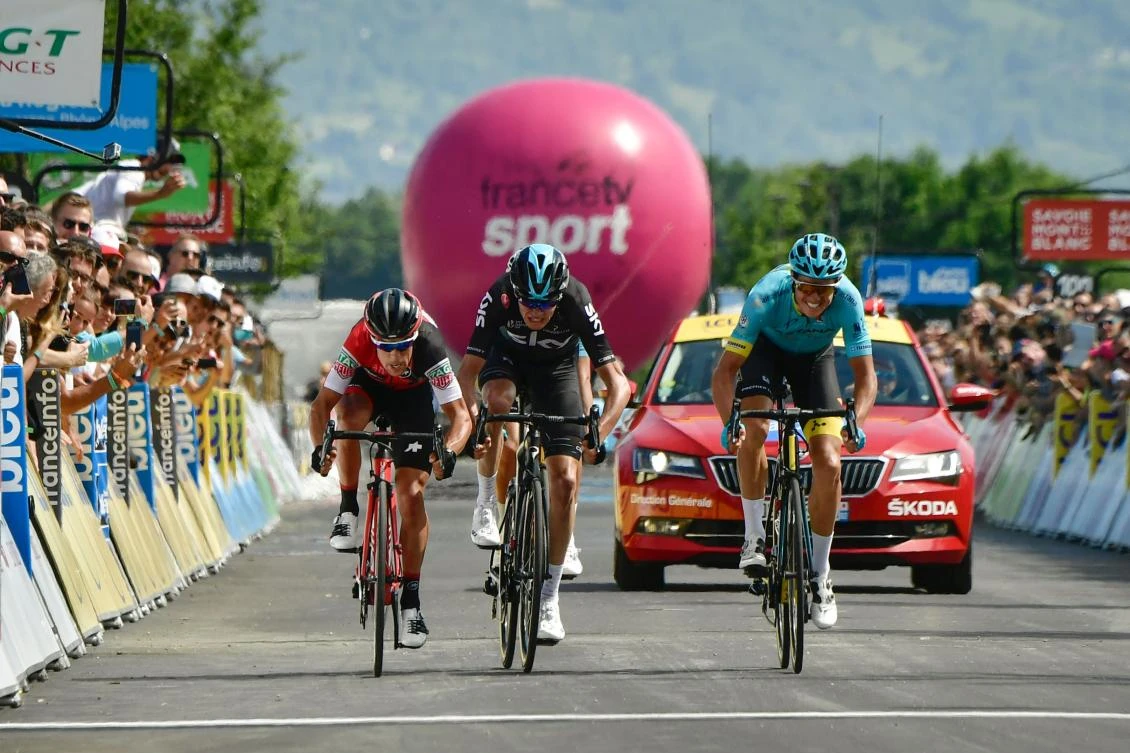 Jakob Diemer Fuglsang, right, crosses the finish line ahead of Richie Porte, left, and Christopher Froome, center, at the end of the 147,5 km sixth stage of the 69th edition of the Criterium du Dauphine cycling race on Friday. (AFP)