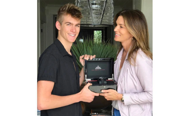 Presley Gerber and his mother Cindy Crawford
hold a gift watch. (Instagram photo)