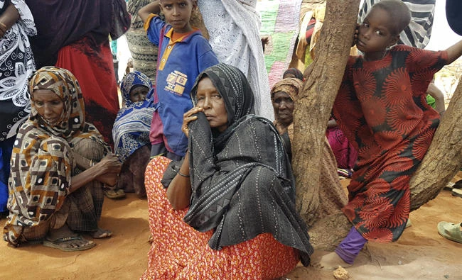 In this photo taken on Friday, Ethiopians wait for an international delegation visiting the Warder town of Ethiopia's drought stricken area near the border with Somalia. Ethiopia's government is warning it will run out of emergency food aid starting next month as the number of drought victims in the East African country has reached 7.8 million. (AP Photo/Elias Meseret )