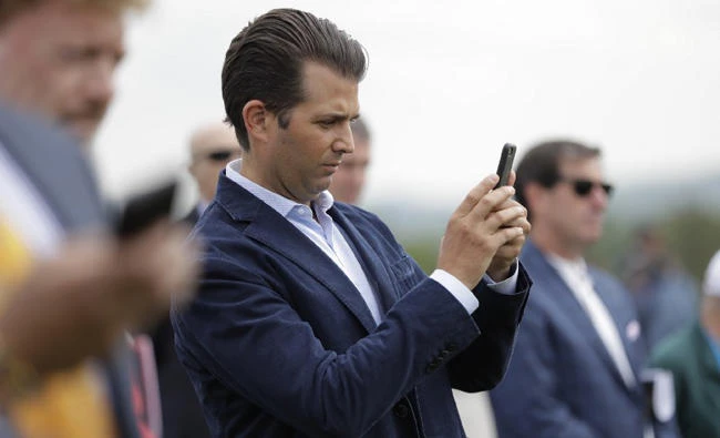 Donald Trump Jr. uses a smartphone to capture images during a media event at Trump National Golf Club. (AP file photo)