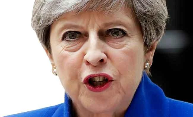 British Prime Minister Theresa May addresses the press in Downing Street, London, on Friday following an audience with Britain's Queen Elizabeth II at Buckingham Palace where she asked to form a government. (AP)