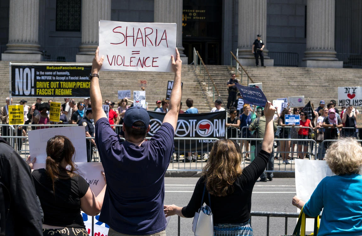 Demonstrators gathered to protest against Islamic law, foreground, stand across from counter demonstrators Saturday, June 10, 2017, in New York. In more than two dozen cities across the United States, the group organizing the rallies, ACT for America, is speaking out against Shariah law, saying it is incompatible with Western democracy. (AP)