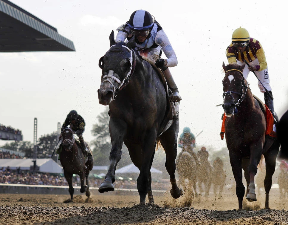 Tapwrit, left, ridden by Jose Ortiz, wins the 149th running of the Belmont Stakes horse race Saturday in Elmont, N.Y. Irish War Cry, ridden by Rajiv Maragh, right, finished second. (AP)