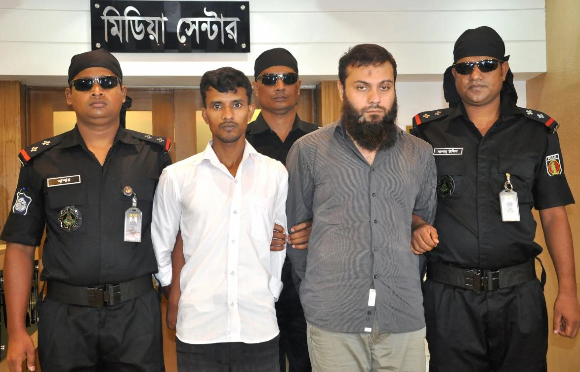 Bangladeshi businessman Imran Ahmed (2nd R), who runs a garment factory, and his driver Shamim Mia (2nd L) being presented to the media following their arrest in Dhaka on Sunday. (Bangladesh Rapid Action Battalion handout photo via AFP)