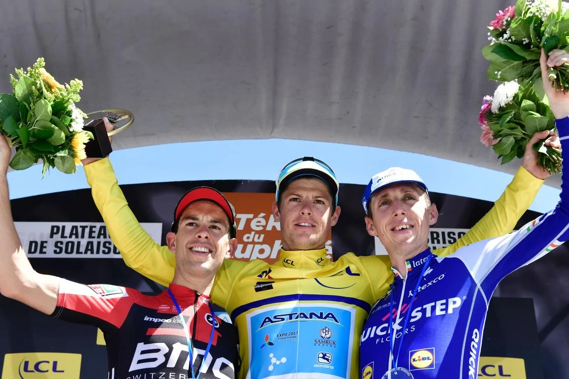 Winner of the Criterium du Dauphine 2017 Denmark's Jakob Fuglsang, center, second-placed Australia's Richie Porte, left, and third-placed Ireland's Daniel Martin celebrate on the podium at the end of the 115 km eighth and last stage of the 69th edition of the Criterium du Dauphine cycling race on Sunday between Albertville and the Plateau de Solaison in Brison, French Alps. (AFP)