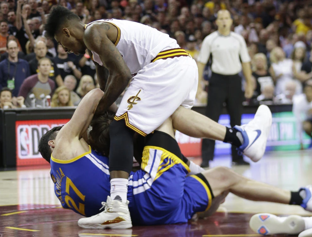 Golden State Warriors center Zaza Pachulia (27) and Cleveland Cavaliers guard Iman Shumpert vie for the ball during the second half of Game 4 of basketball's NBA Finals in Cleveland on Friday. After two straight Golden State blowouts to open the series and a thrilling comeback in Game 3, things turned feisty in Game 4 as the teams that are meeting in a third straight Finals showed some animosity. (AP)