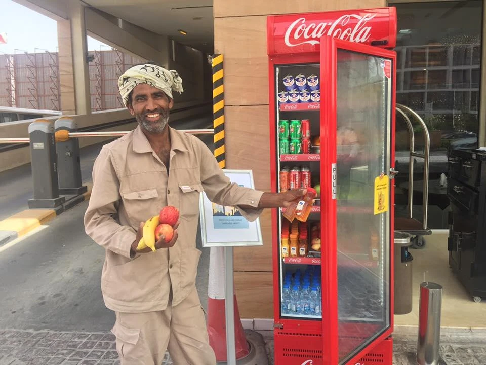 Worker grabbing a light meal from Dubai's Ramadan sharing fridge. (Photo courtesy: Facebook)