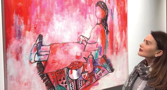 Saudi artist Ola Hejazi displays her painting of a girl making Dua’a (supplication) to Allah.