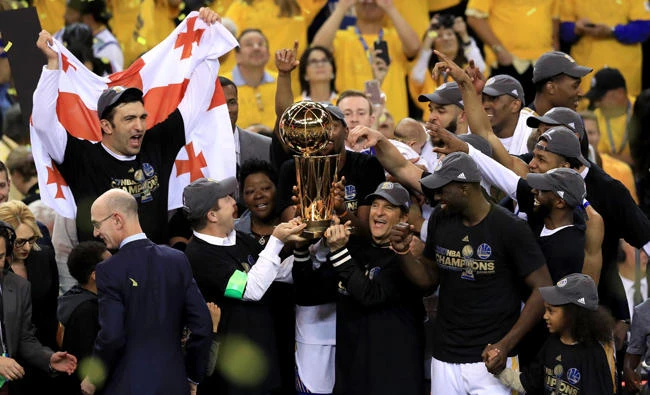 The Golden State Warriors celebrate with the Larry O'Brien Trophy after defeating the Cleveland Cavaliers 129-120 in Game 5 to win the 2017 NBA Finals at Oracle Arena on Monday in Oakland, California. (Ronald Martinez/Getty Images/AFP)