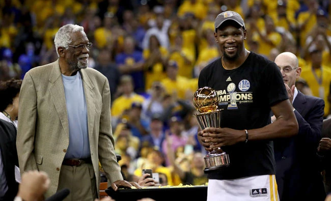 Kevin Durant #35 of the Golden State Warriors is presented the Bill Russell NBA Finals Most Valuable Player Trophy by NBA Hall of Famer Bill Russell after defeating the Cleveland Cavaliers 129-120 in Game 5 to win the 2017 NBA Finals in Oakland, California, on Monday. (Ezra Shaw/Getty Images/AFP)