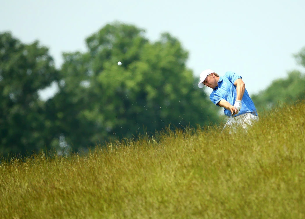 Jordan Spieth hits out of the tall grass off the 8th fairway during a practice round for the US Open golf tournament at Erin Hills on Monday. (USA TODAY Sports)