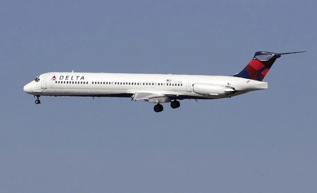 In this April 6, 2013 photo, a Delta Airlines jet flies over Citi Field in New York. An American woman is suing the airliner, claiming it could have prevented a man from molesting her on a flight from South Carolina in 2016. (AP File)