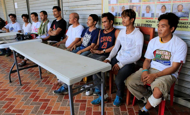 Rescued policemen and civilians who were trapped during fighting between government troops against insurgents from the Maute group, who has taken over large parts of the Marawi city, answer questions during a conference in Marawi city, Philippines on Tuesday. (REUTERS/Romeo Ranoco)