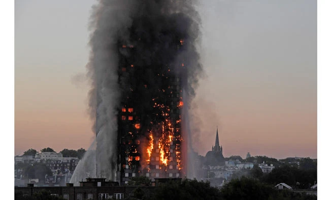 Flames and smoke billow as firefighters deal with a serious fire in the Grenfell Tower apartment block at Latimer Road in London on Wednesday. (REUTERS/Toby Melville)
