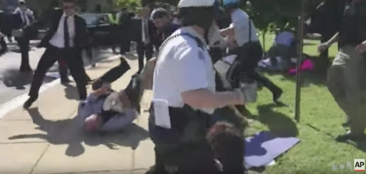 In this still image taken from a YouTube video, US police clash try to stop a clash between supporters and opponents of Turkish President Recep Tayyip Erdogan outside the Turkish Embassy in the US capital in early May as Erdogan met with President Trump. (From Voice of America video via AP)
