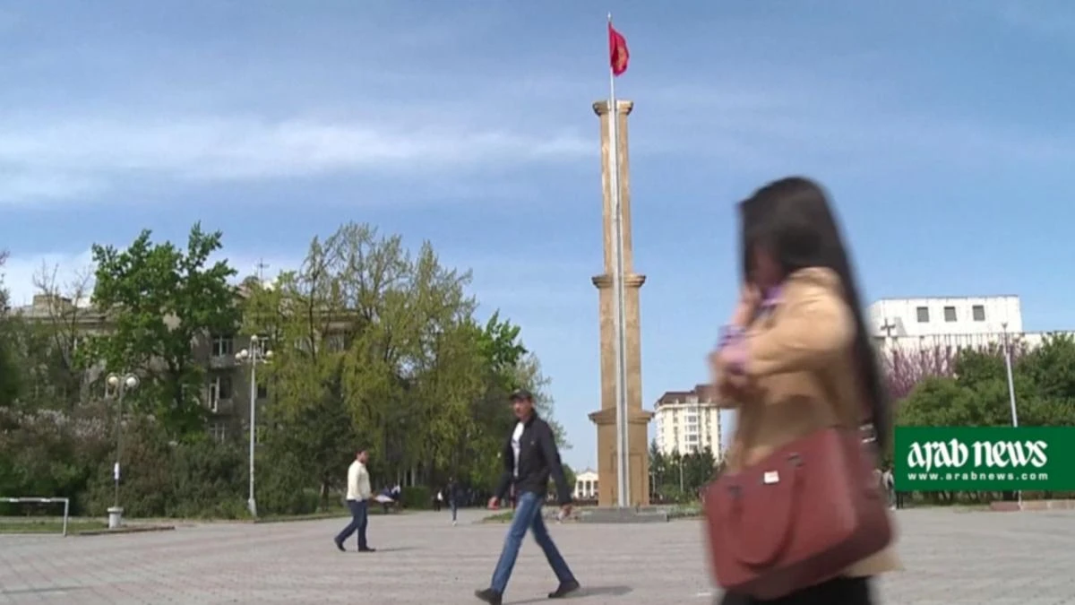 A woman journalist is seen strolling across a square Bishek, Kyrgyzstan in this picture. (AFP photo)
