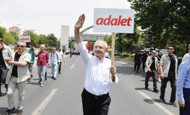 Turkey’s main opposition leader, Kemal Kilicdaroglu, attends a protest against detention of CHP lawmaker Enis Berberoglu, in Ankara, on Thursday. Placard reads “Justice.” (Reuters)