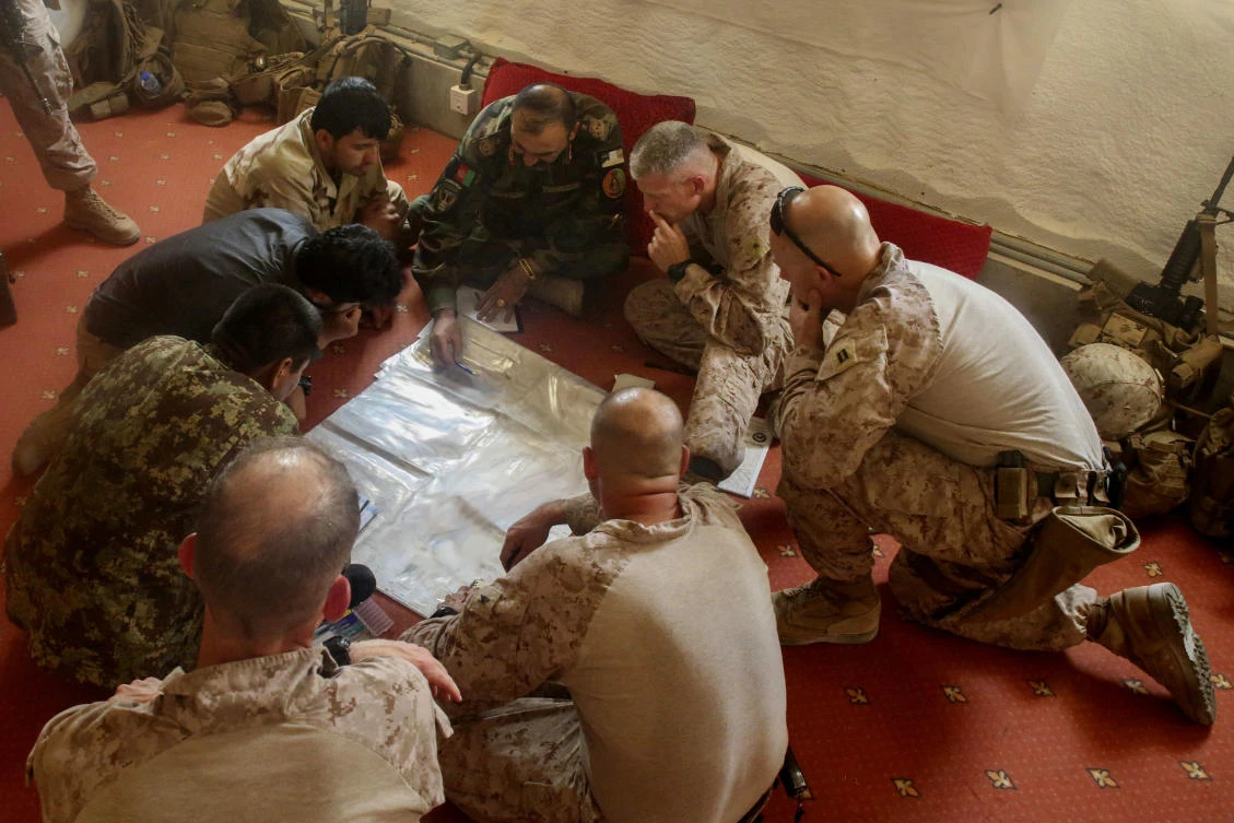 US soldiers plan for the continuation of an offensive combat operation at Camp Hanson, Afghanistan, on Tuesday. (AP)
