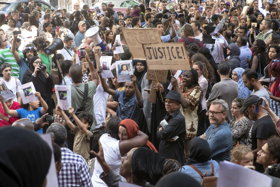 People gather outside Kensington Town Hall during protests following the Grenfell Tower fire in London, Friday June 16, 2017. (AP)