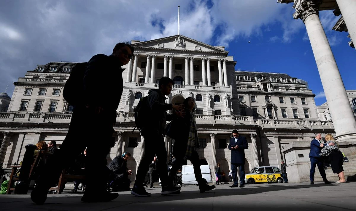People walking past The Bank of England in the City of London. (AFP)