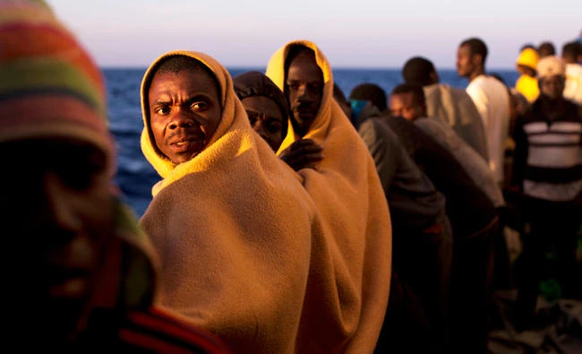 Men stand on the deck of the rescue vessel Golfo Azzurro after being rescued by Spanish NGO Proactiva Open Arms workers on the Mediterranean Sea on Friday. (AP)