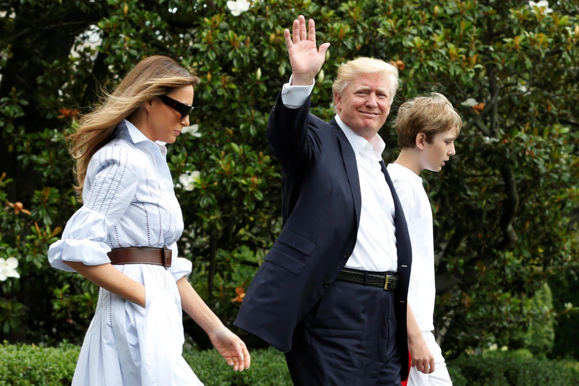U.S. President Donald Trump with first lady Melania and their son Barron walk out from the White House in Washington, US. (Reuters)