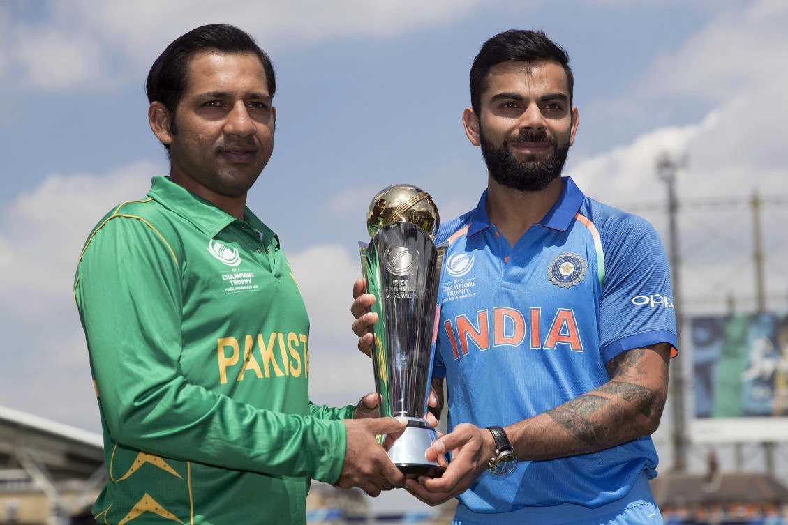 India's captain Virat Kohl, right, and Pakistan's captain Sarfraz Ahmed pose for a picture with the trophy at the Oval cricket ground in London Saturday, ahead of the two teams' clash in the ICC Champions Trophy final cricket match at the Oval on Sunday. (AP)