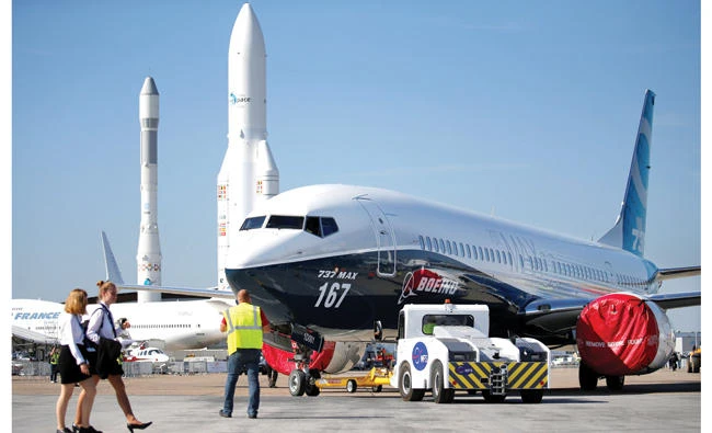Workers move a Boeing 737 MAX on static display, before the opening of the 52nd Paris Air Show at Le Bourget Airport near Paris, France. (Reuters)