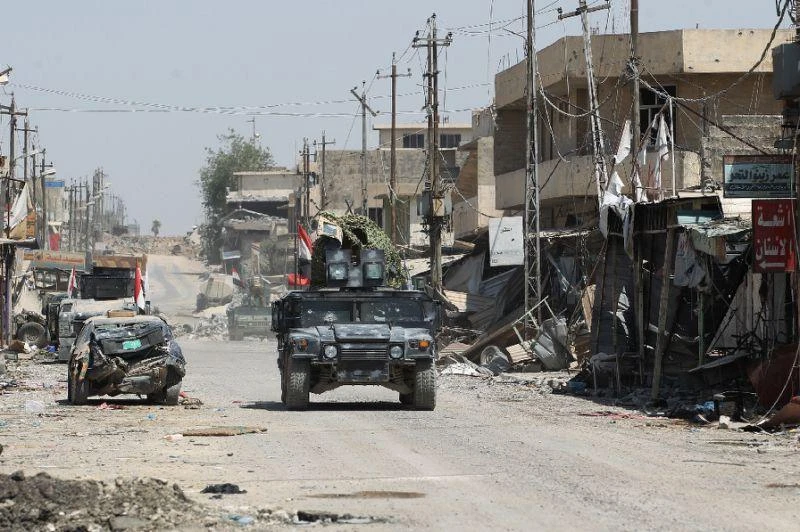 Iraqi forces, consisting of the Iraqi federal police and the elite Rapid Response Division, patrol in the Shifa neighborhood, on the west bank of Mosul, on Saturday. (AFP)