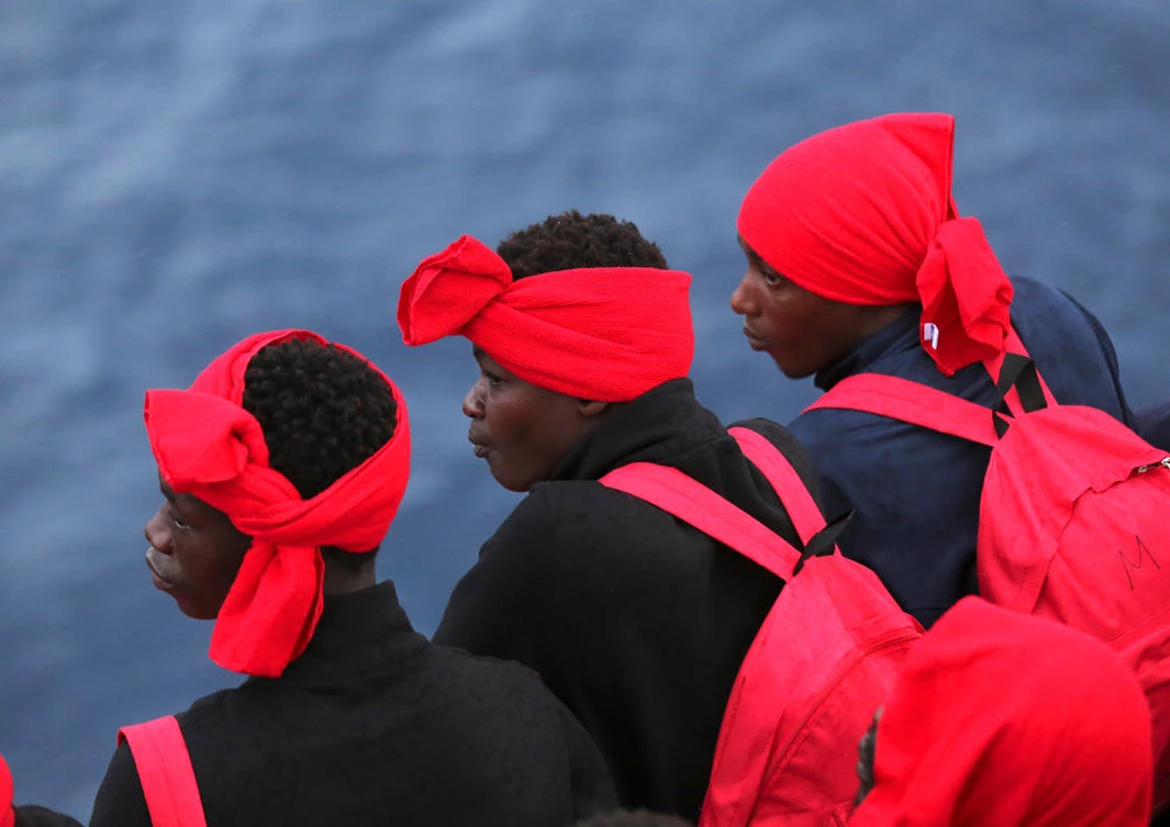 Migrants look on from Vos Hestia ship after being rescued by "Save the Children" NGO crew in the Mediterranean sea off Libya coast. (Reuters)