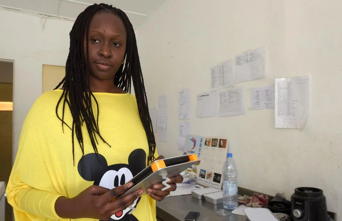 Senegalese restaurant owner and Weebi user Marieme Assi Diagne, poses with a digital tablet at her office in Dakar. Although just 40 users so far have the app, which is a standalone download or can be bought for 118,000 FCFA ($200) preloaded onto a tablet, 300 clients have shown an interest in the product in the Dakar area. (AFP)
AFP