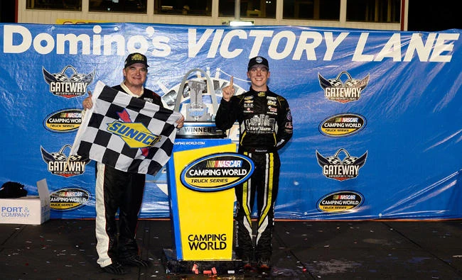 John Hunter Nemechek, driver of the #8 Chevrolet Silverado, and his father Joe Nemechek pose for a photo after winning the NASCAR Camping World Trucks Series Drivin' for Linemen 200 at Gateway Motorsports Park on Saturday in Madison, Illinois. (AFP)