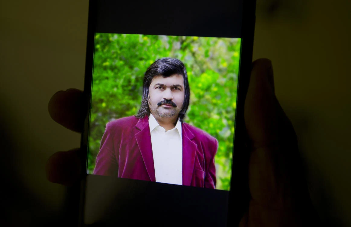 In this Tuesday, June 13, 2017 photo. a family member shows the photograph of assassinated Pakistani journalist Bakhsheesh Elahi in Haripur, Pakistan. Elahi was waiting for the morning bus when a lone gunman on a motorcycle pulled up beside him and shot him dead. Rights groups say journalists in Pakistan are under escalating attacks as from multiple directions. (AP)
