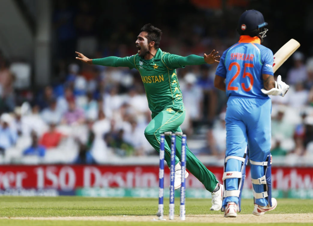 Mohammad Amir celebrates taking the wicket of India's Shikhar Dhawan during the ICC Champions Trophy final on Sunday. (Reuters)