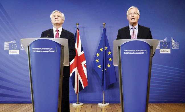 The EU's Michel Barnier, right, speaks as David Davis looks on during a statement before the negotiation of Brexit at the EU headquarters in Brussels on Monday. (AFP)