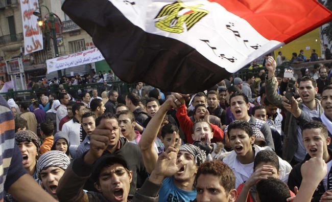 Egyptians protest at Tahrir Square in Cairo on Nov. 27, 2011 to demand that the country’s military rulers step down. In January 2015, a protest march marking the 2011 uprising resulted in the death of Shaimaa Sabbagh when a police officer indiscriminately fired at them. (AP file photo)