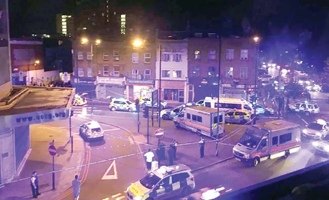 Police vehicles surround a crime scene after a vehicle hit pedestrians in London on Monday. (AFP)