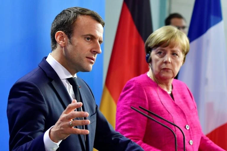 German Chancellor Angela Merkel and French President Emmanuel Macron say they are ready to change EU treaties if necessary. (AFP)