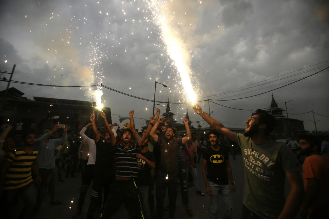 Kashmiris light fire crackers as they celebrate India losing two early wickets during the Champions Trophy cricket final match between India and Pakistan, in Srinagar, Indian controlled Kashmir, Sunday, June 18, 2017. Later in the day Pakistan defeated India by 180 runs to lift the cup. (AP)