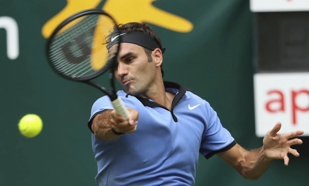 Switzerland's Roger Federer in action against Japan's Yuichi Sugita during their match at the Gerry Weber Open ATP tennis tournament in Halle, Germany, Tuesday. (AP)