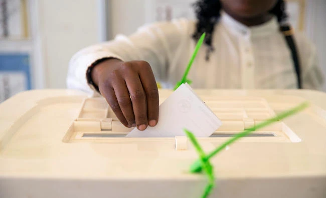 A Kenyan woman casts her vote at a mock polling station during a pre-election exhibition in Nairobi, Kenya, earlier this month. (Reuters)